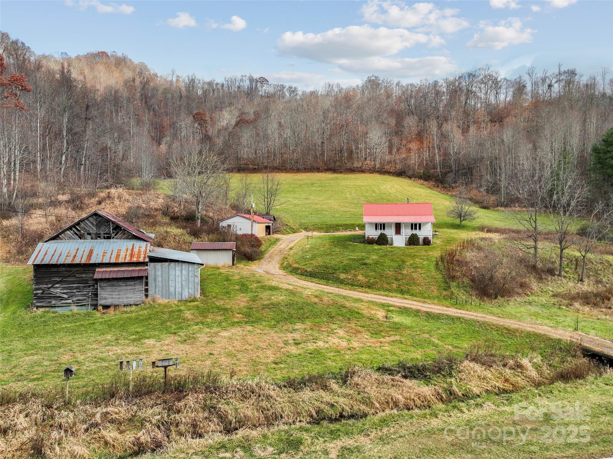 456 Windy Gap Road Mars Hill, NC 28754 - Photo 2 of 47 a backyard of a house with table and chairs