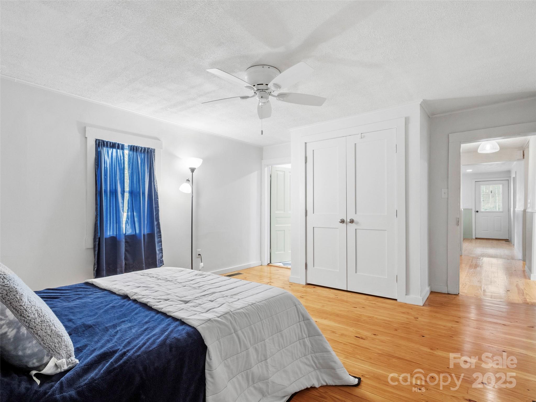 456 Windy Gap Road Mars Hill, NC 28754 - Photo 21 of 47 a bedroom with a bed and a chandelier