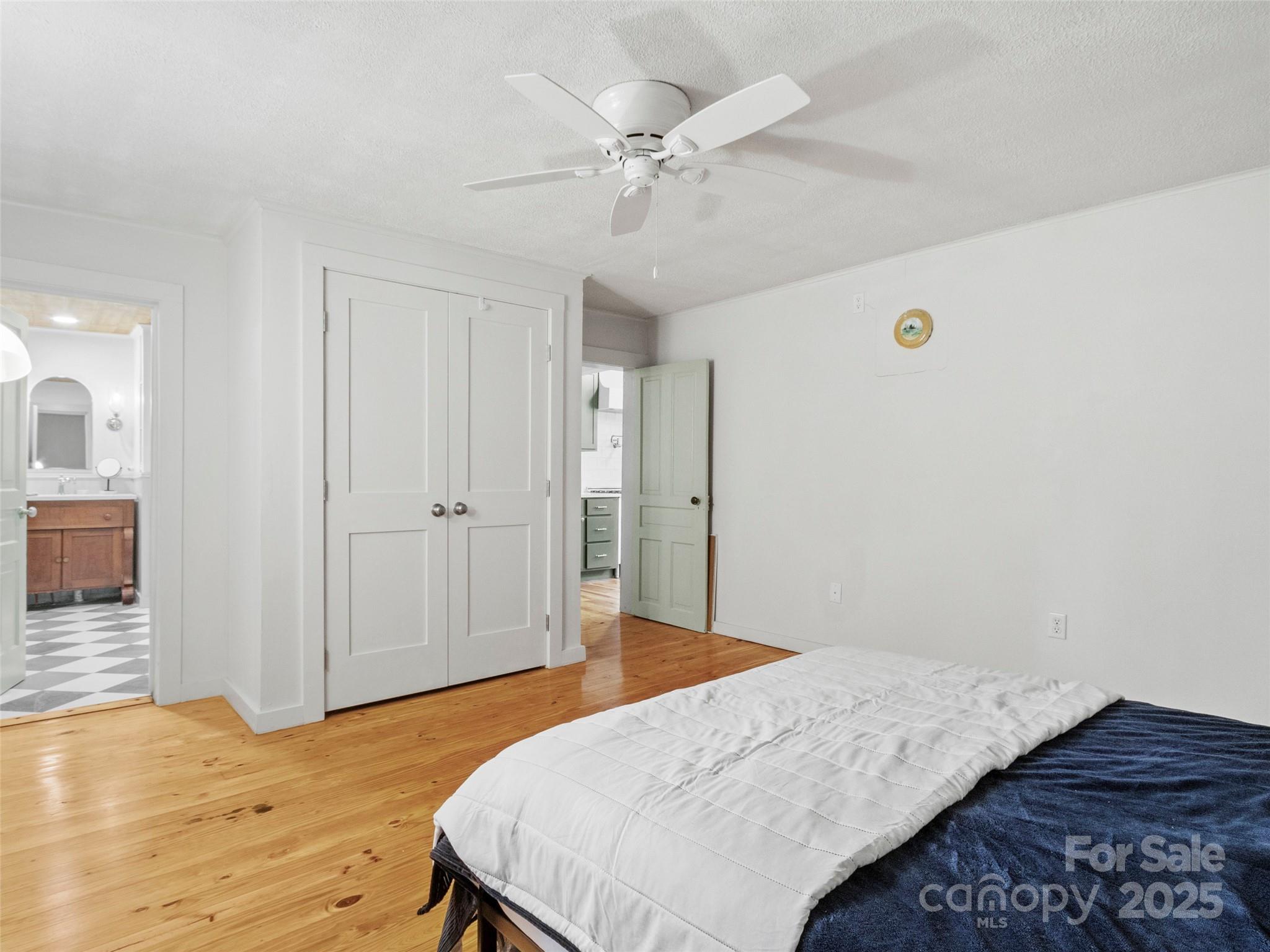 456 Windy Gap Road Mars Hill, NC 28754 - Photo 22 of 47 a bedroom with a bed and a chandelier
