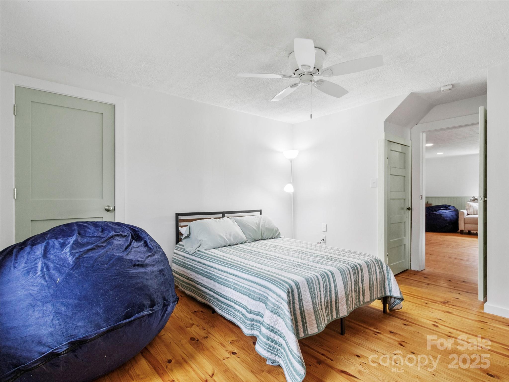 456 Windy Gap Road Mars Hill, NC 28754 - Photo 24 of 47 a bedroom with bed and a chandelier