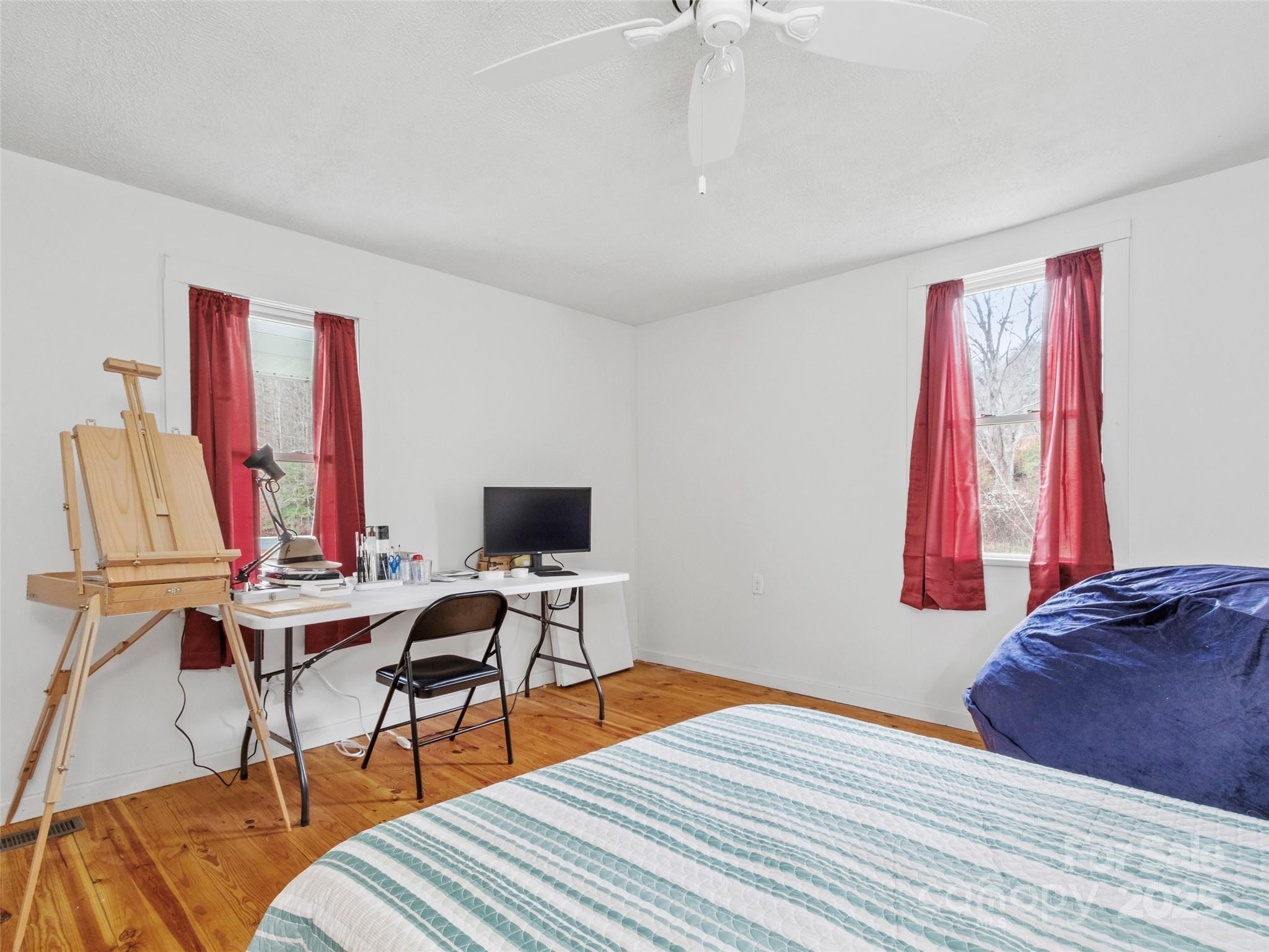 456 Windy Gap Road Mars Hill, NC 28754 - Photo 25 of 47 a bedroom with a bed and a desk