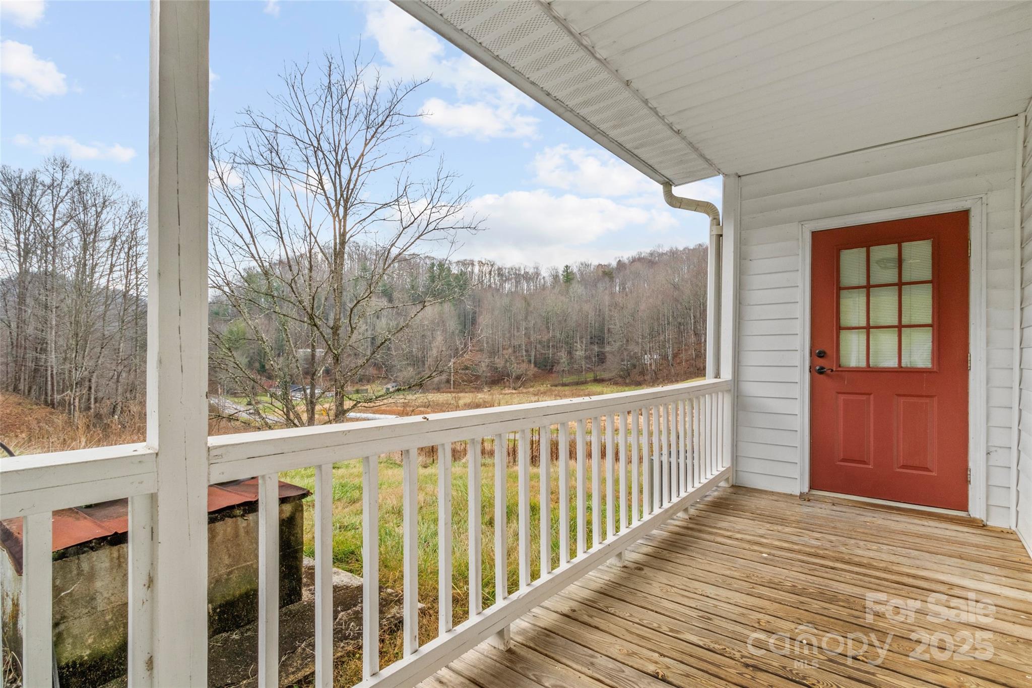 456 Windy Gap Road Mars Hill, NC 28754 - Photo 35 of 47 a view of a balcony with wooden floor and fence