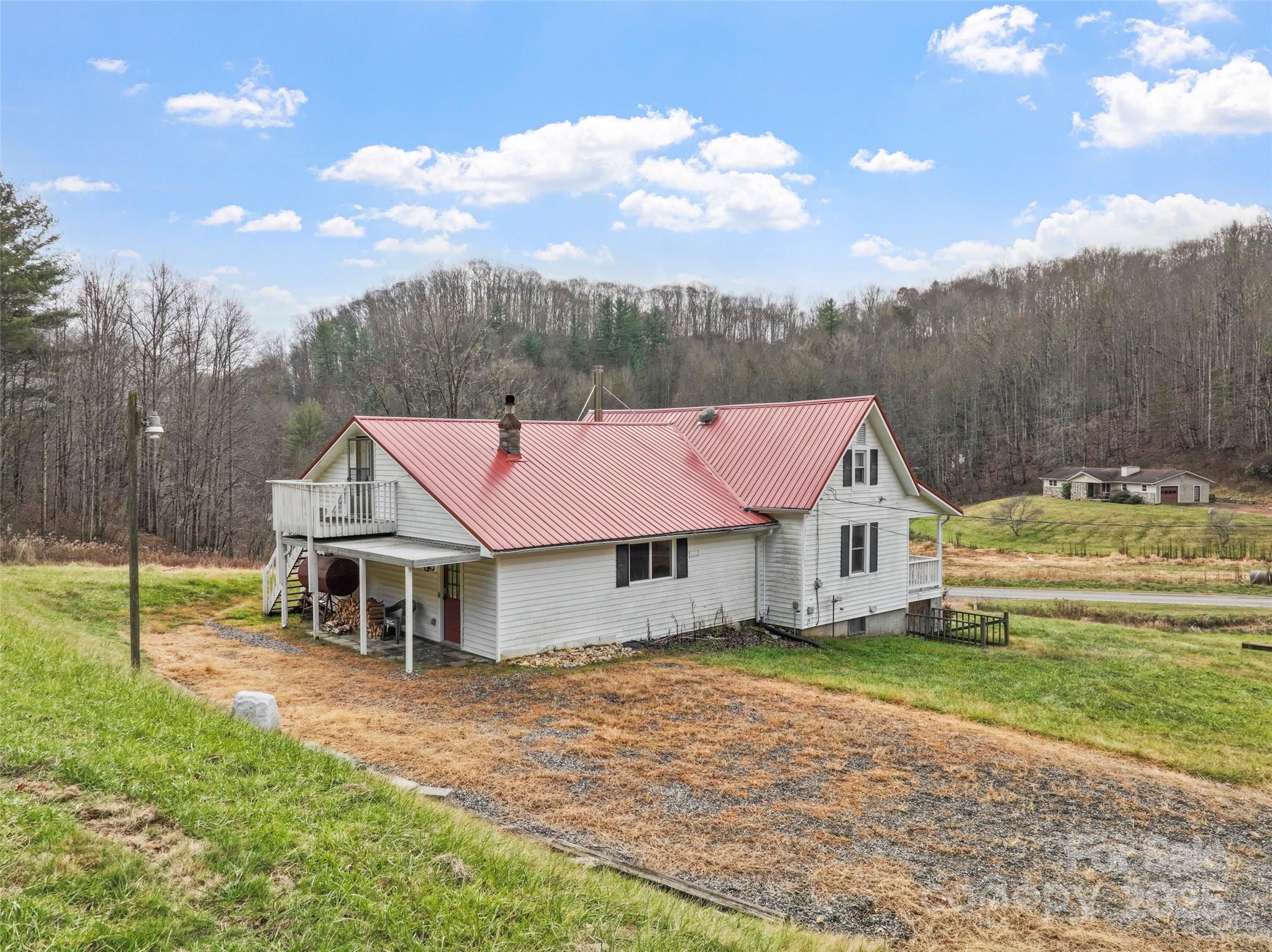 456 Windy Gap Road Mars Hill, NC 28754 - Photo 37 of 47 a view of a house with a yard and sitting area