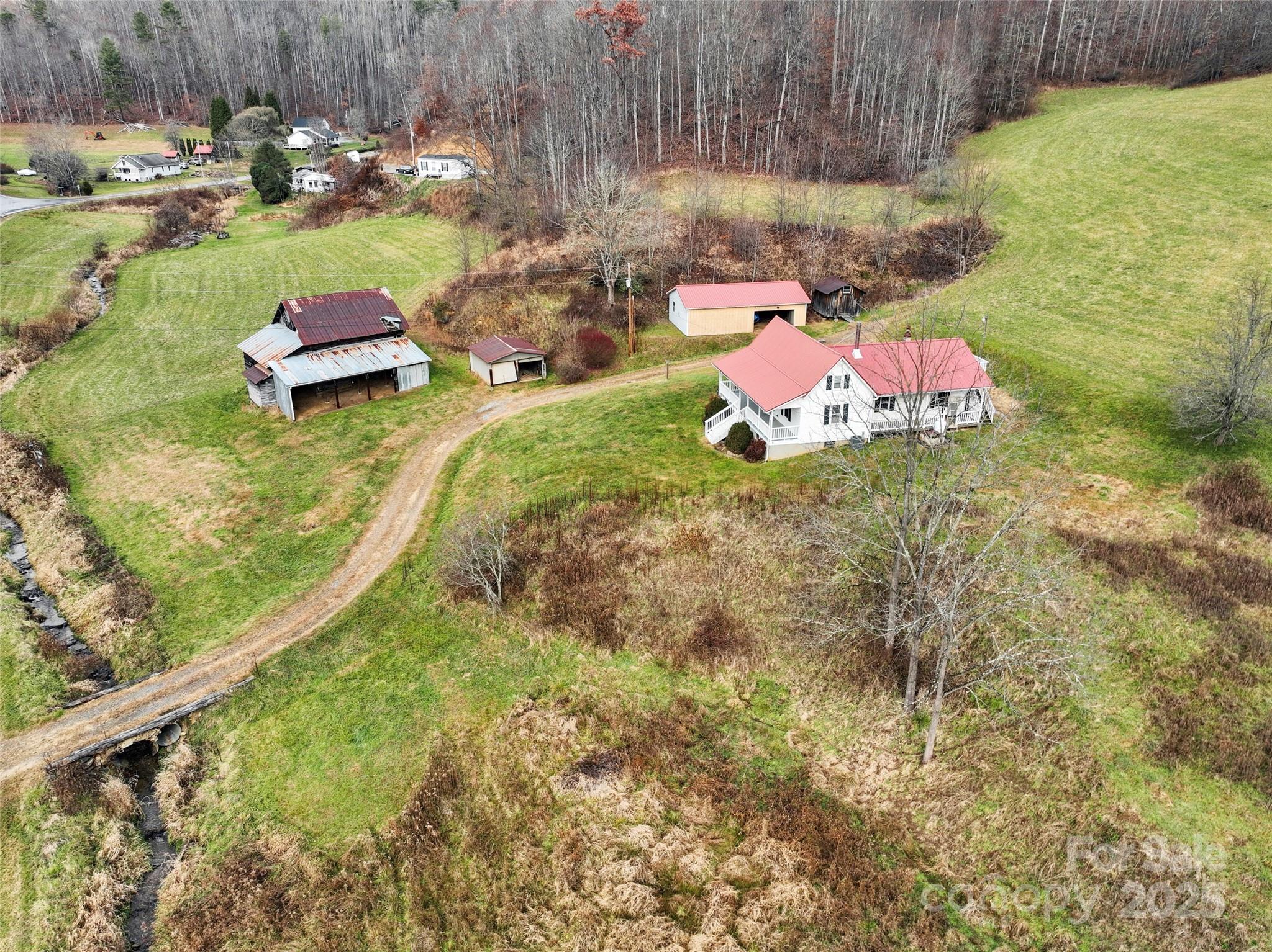 456 Windy Gap Road Mars Hill, NC 28754 - Photo 45 of 47 a view of a yard with an outdoor space