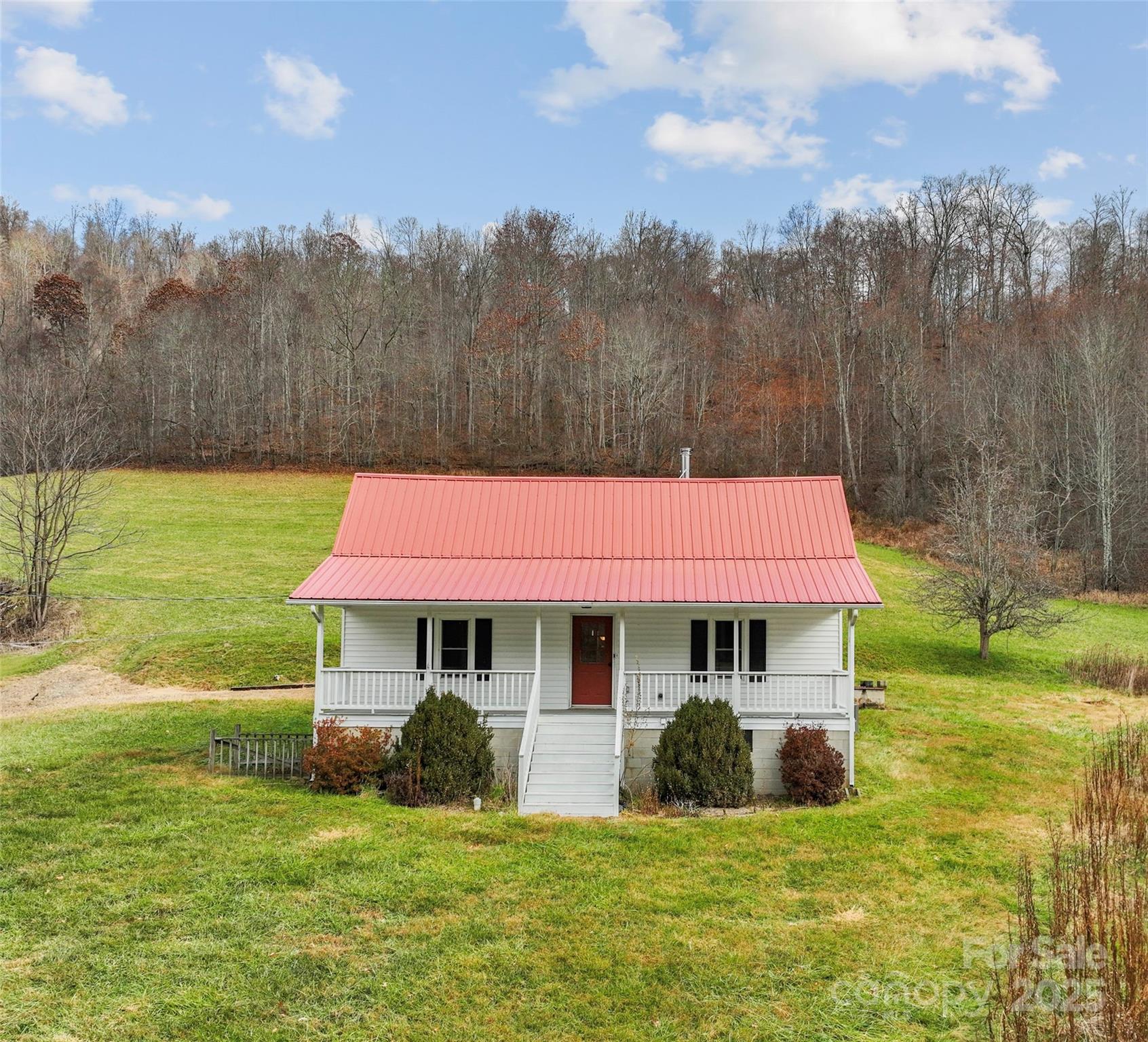 456 Windy Gap Road Mars Hill, NC 28754 - Photo 8 of 47 a view of a house with a yard porch and sitting area