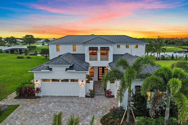 a house with green field in front of it