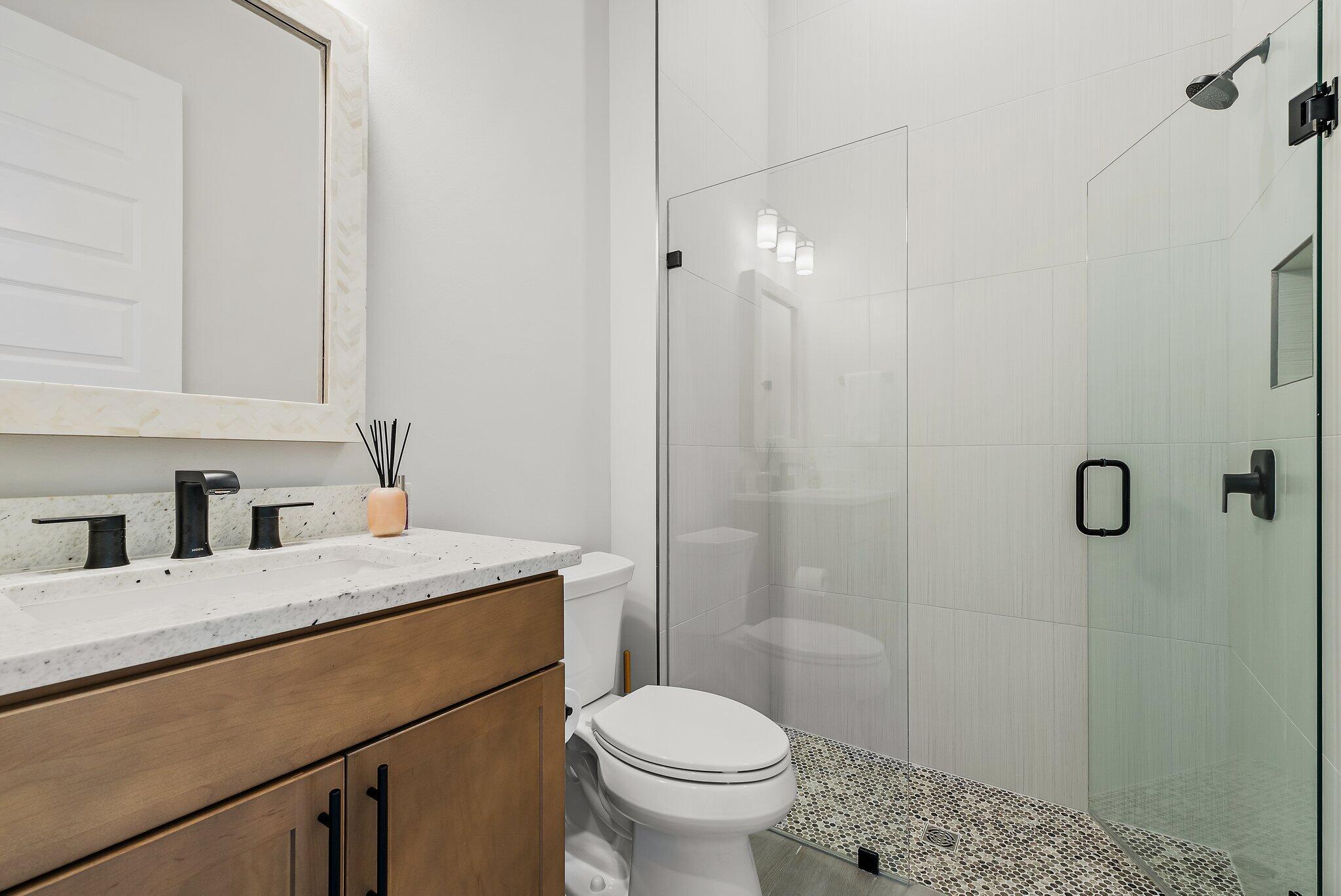 20049 Southeast Bridgewater Drive Jupiter, FL 33458 - Photo 17 of 77 a bathroom with a granite countertop sink toilet and shower