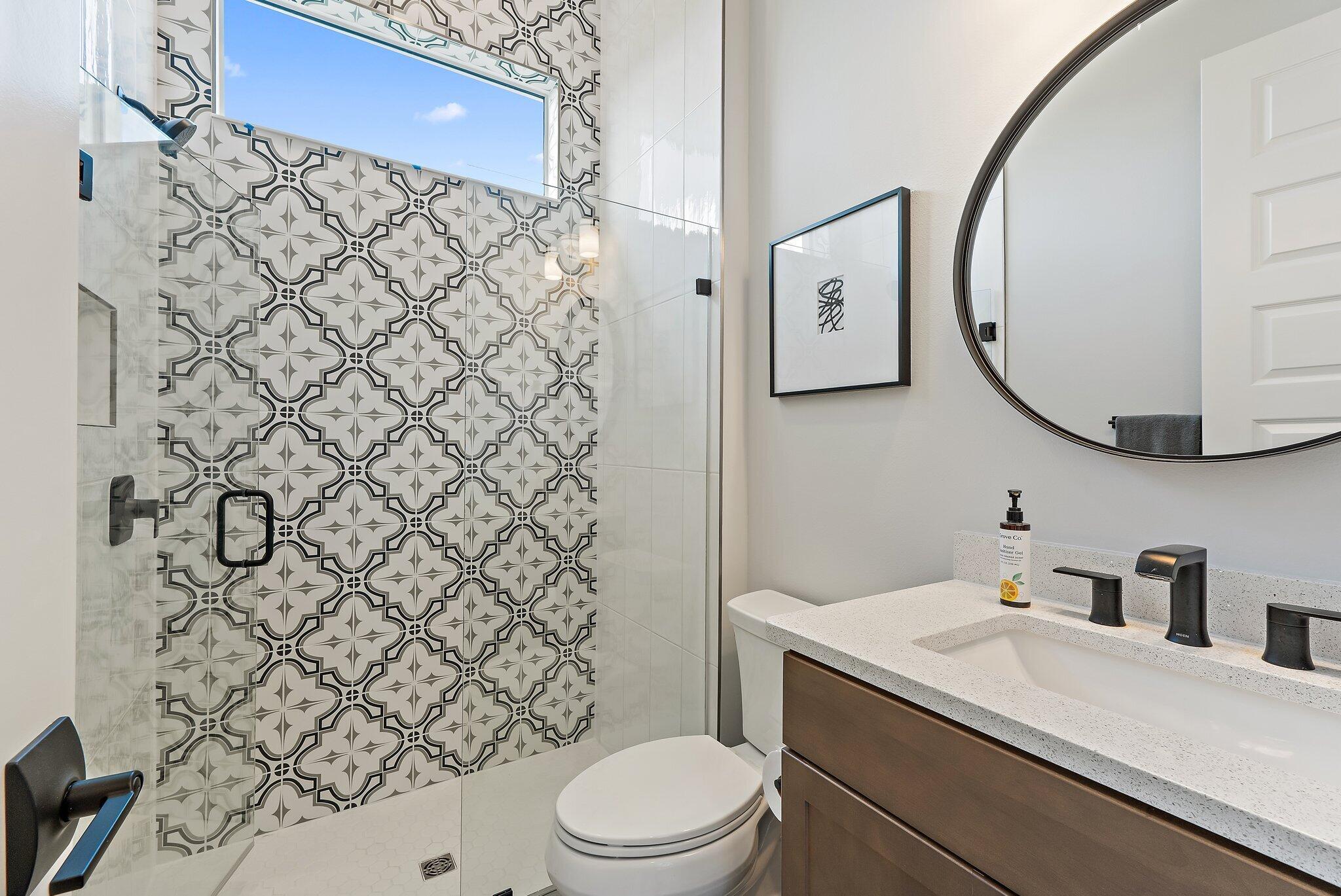 20049 Southeast Bridgewater Drive Jupiter, FL 33458 - Photo 21 of 77 a bathroom with a toilet sink vanity and shower