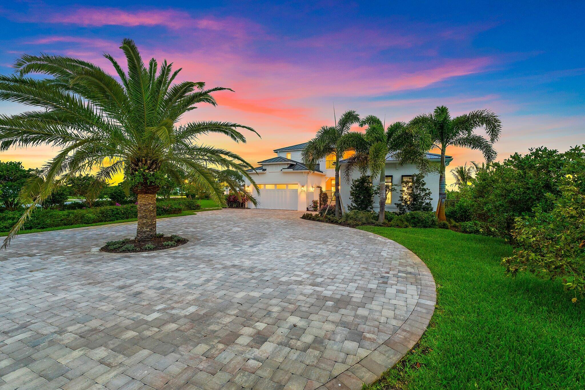 20049 Southeast Bridgewater Drive Jupiter, FL 33458 - Photo 36 of 77 a palm tree sitting in front of a house with a garden
