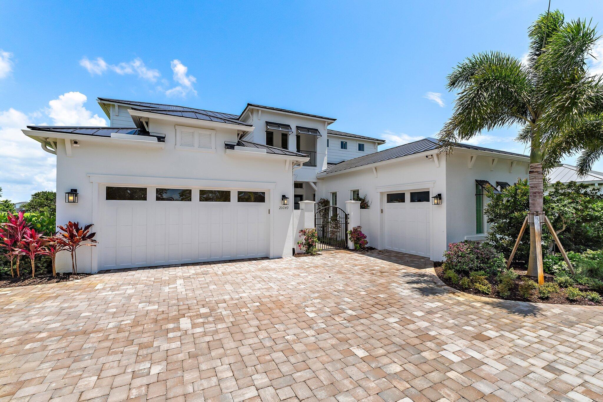 20049 Southeast Bridgewater Drive Jupiter, FL 33458 - Photo 46 of 77 a front view of a house with a yard and potted plants