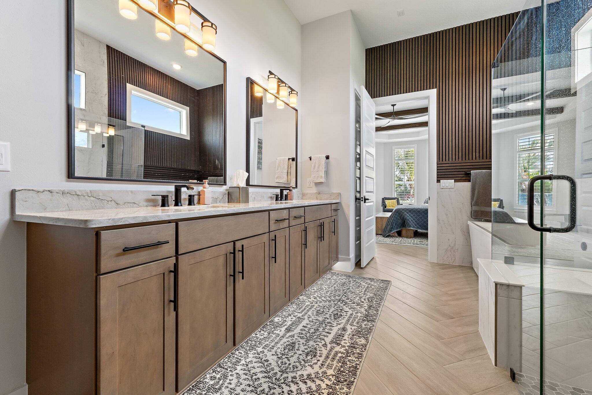 20049 Southeast Bridgewater Drive Jupiter, FL 33458 - Photo 67 of 77 a en suite bathroom with a double vanity sink a mirror and a bathtub