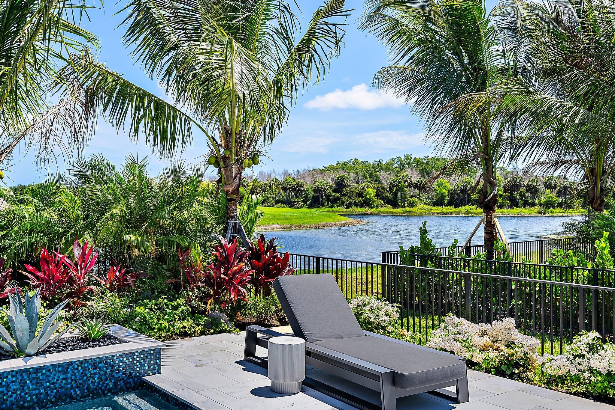 20049 Southeast Bridgewater Drive Jupiter, FL 33458 - Photo 76 of 77 a view of a chair and table in the garden and potted plants