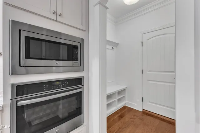 a kitchen with a stove a sink and a wooden cabinets