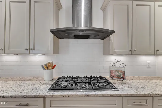 a bathroom with a granite countertop sink toilet a mirror a shower and a mirror