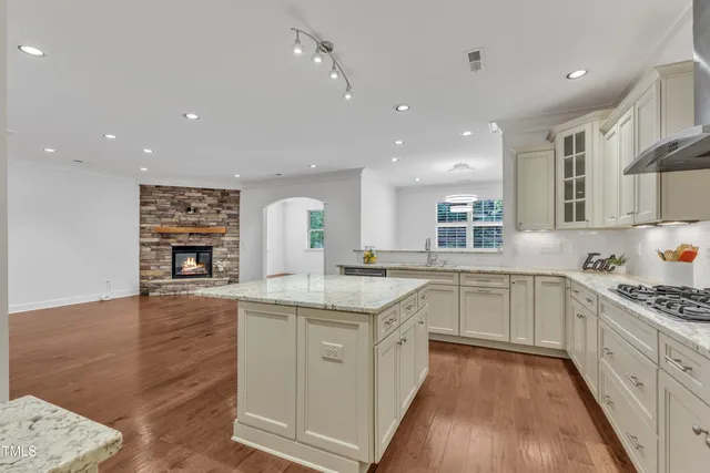 a view of a kitchen with furniture and wooden floor