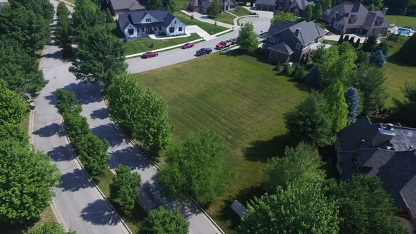 an aerial view of house with yard swimming pool and outdoor seating