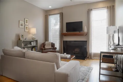 a living room with furniture a flat screen tv and a fireplace