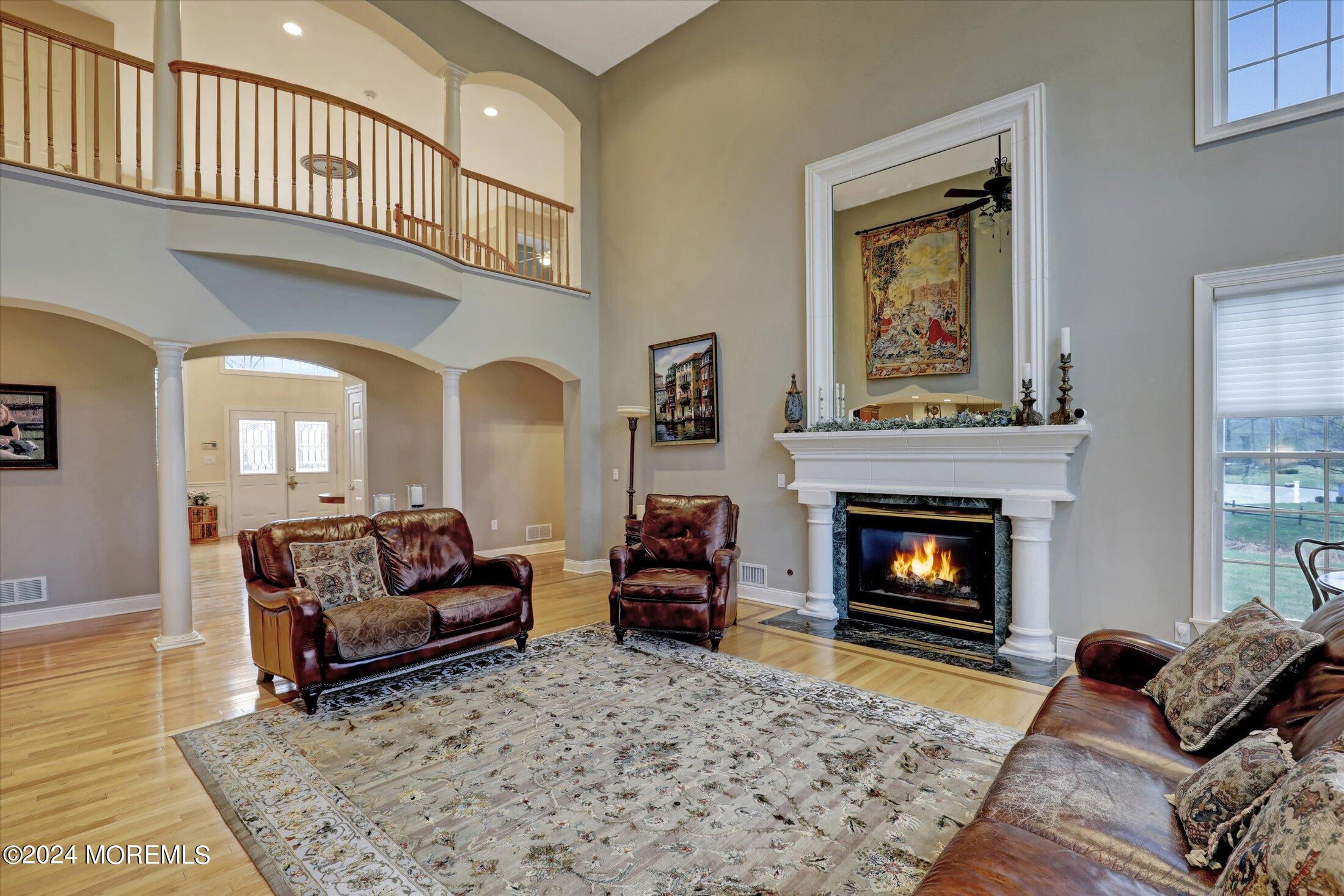 9 Shady Tree Lane Colts Neck, NJ 07722 - Photo 13 of 60 a living room with furniture or couch and a fireplace
