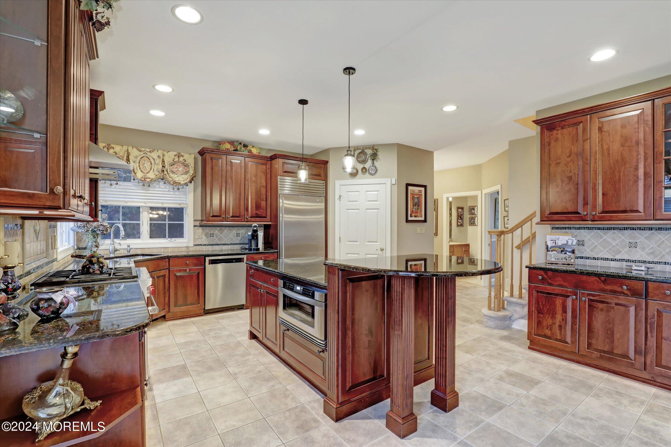 9 Shady Tree Lane Colts Neck, NJ 07722 - Photo 16 of 60 a kitchen with stainless steel appliances granite countertop a stove top oven a sink dishwasher and a refrigerator