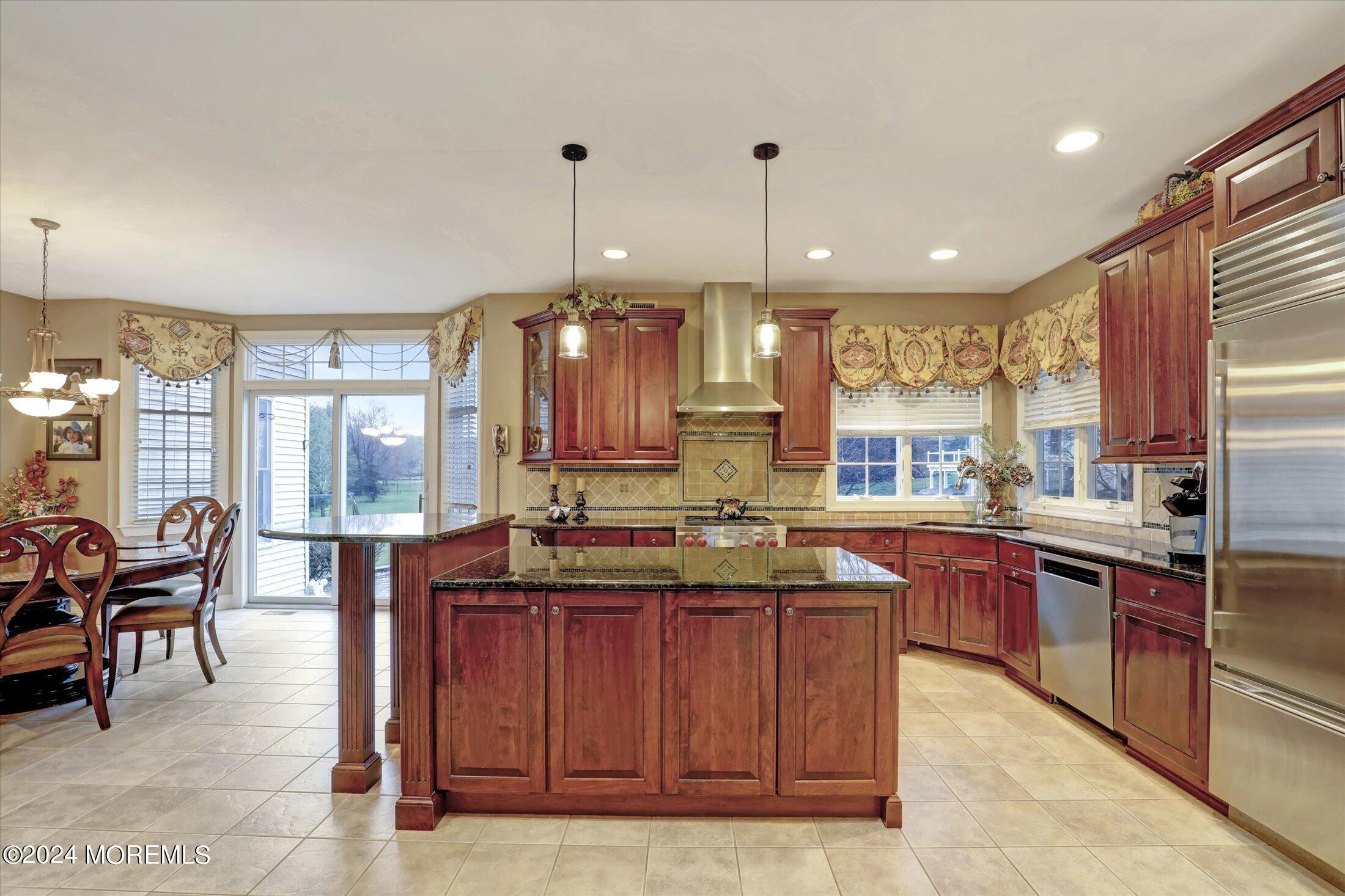 9 Shady Tree Lane Colts Neck, NJ 07722 - Photo 17 of 60 a kitchen with stainless steel appliances granite countertop sink stove and table