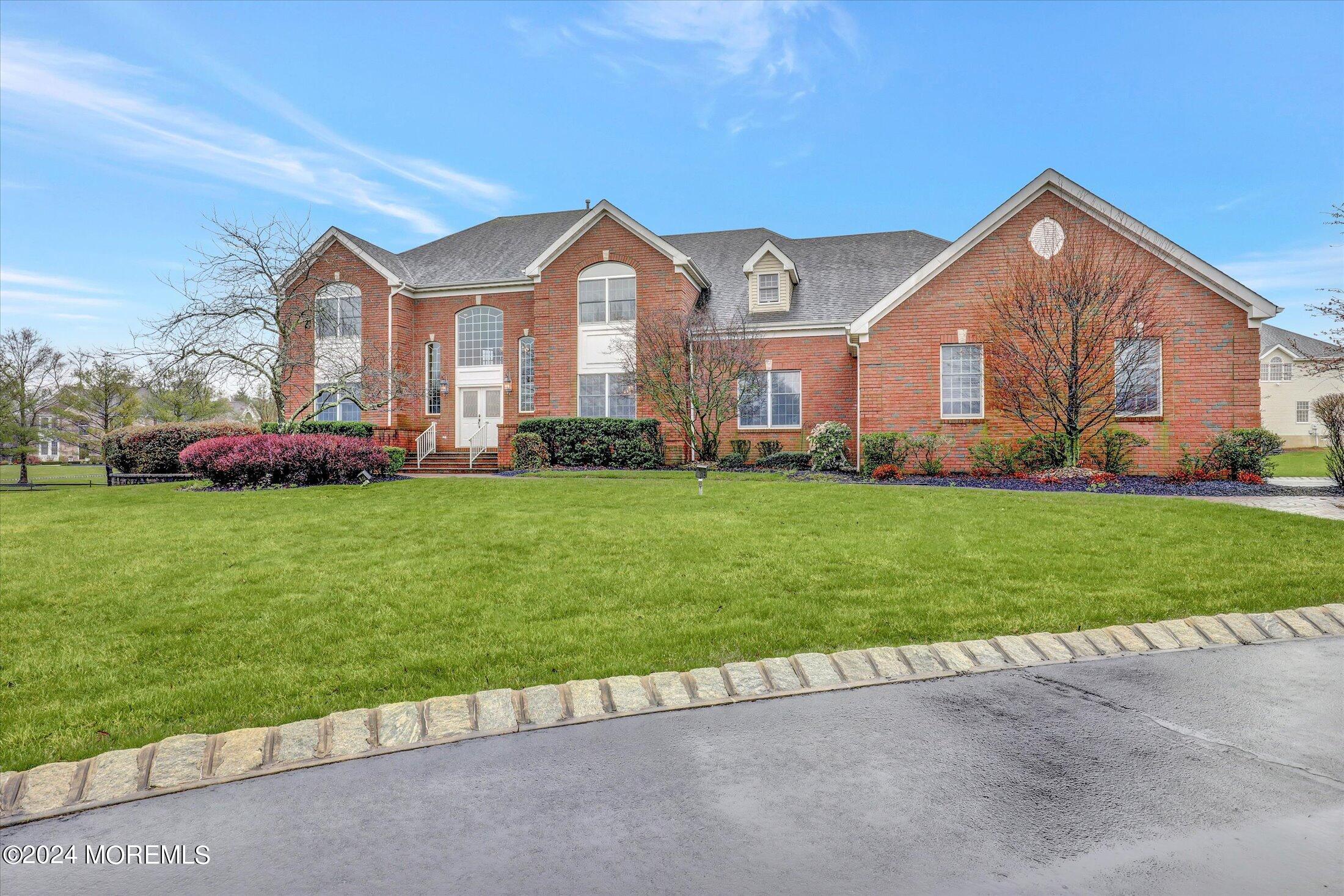 9 Shady Tree Lane Colts Neck, NJ 07722 - Photo 3 of 60 a front view of a house with a garden and plants
