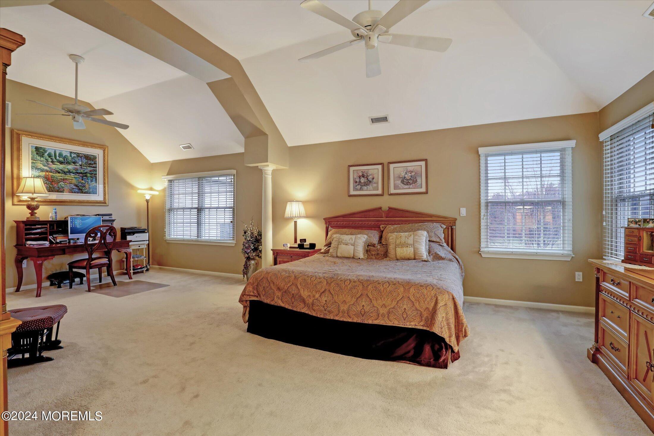 9 Shady Tree Lane Colts Neck, NJ 07722 - Photo 33 of 60 a bedroom with a bed and a chandelier