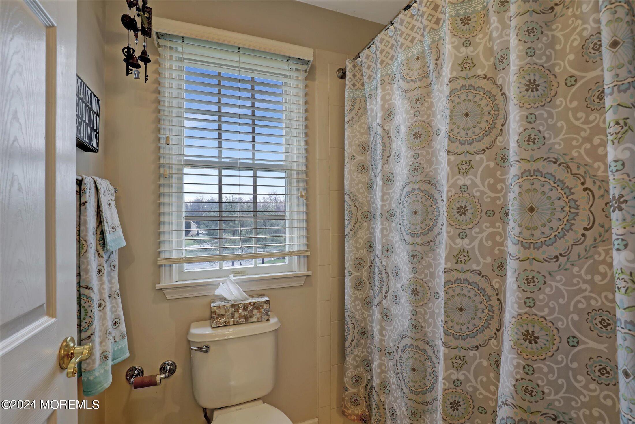 9 Shady Tree Lane Colts Neck, NJ 07722 - Photo 41 of 60 a bathroom with a granite countertop window a toilet and a shower