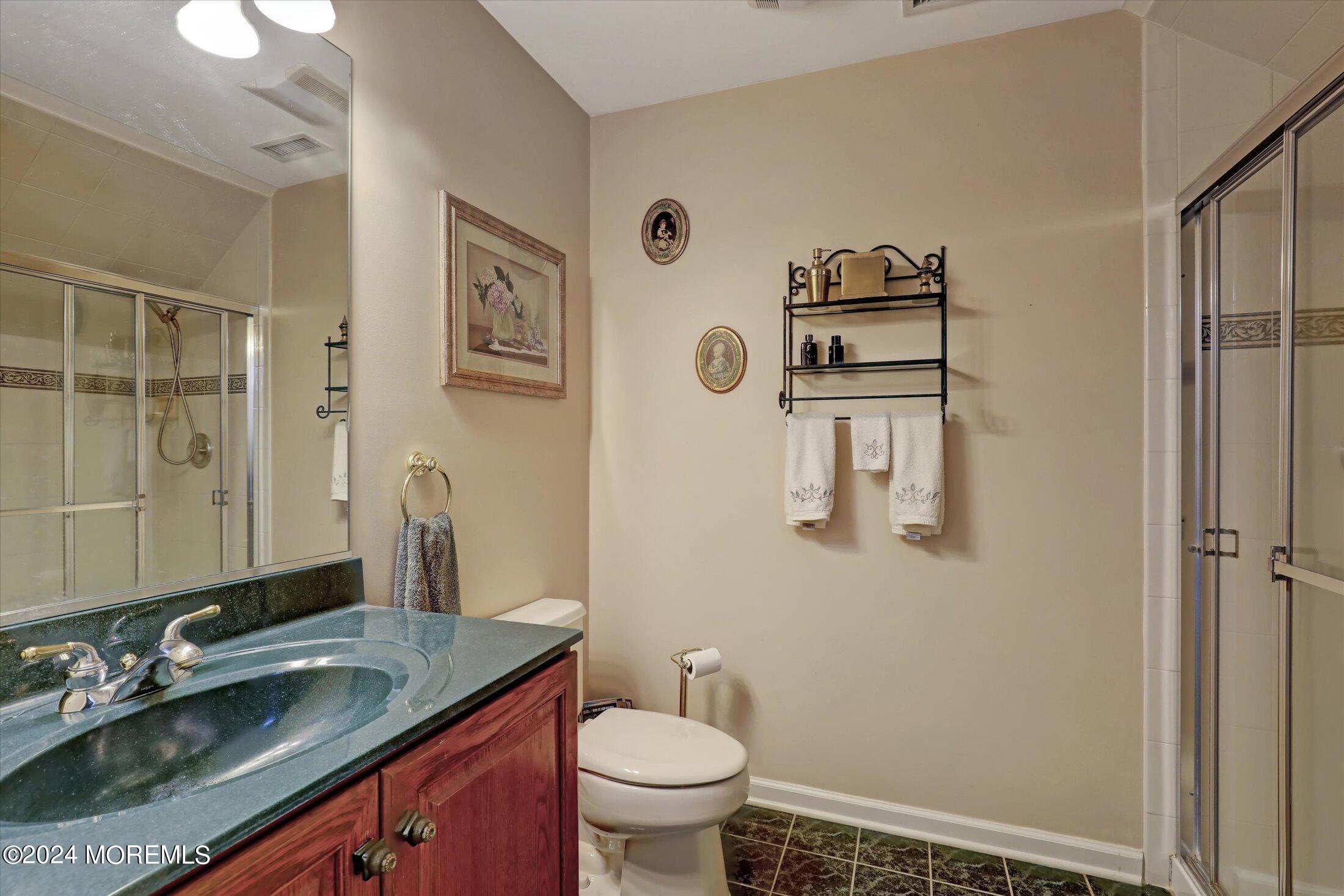 9 Shady Tree Lane Colts Neck, NJ 07722 - Photo 44 of 60 a bathroom with a granite countertop sink toilet and mirror