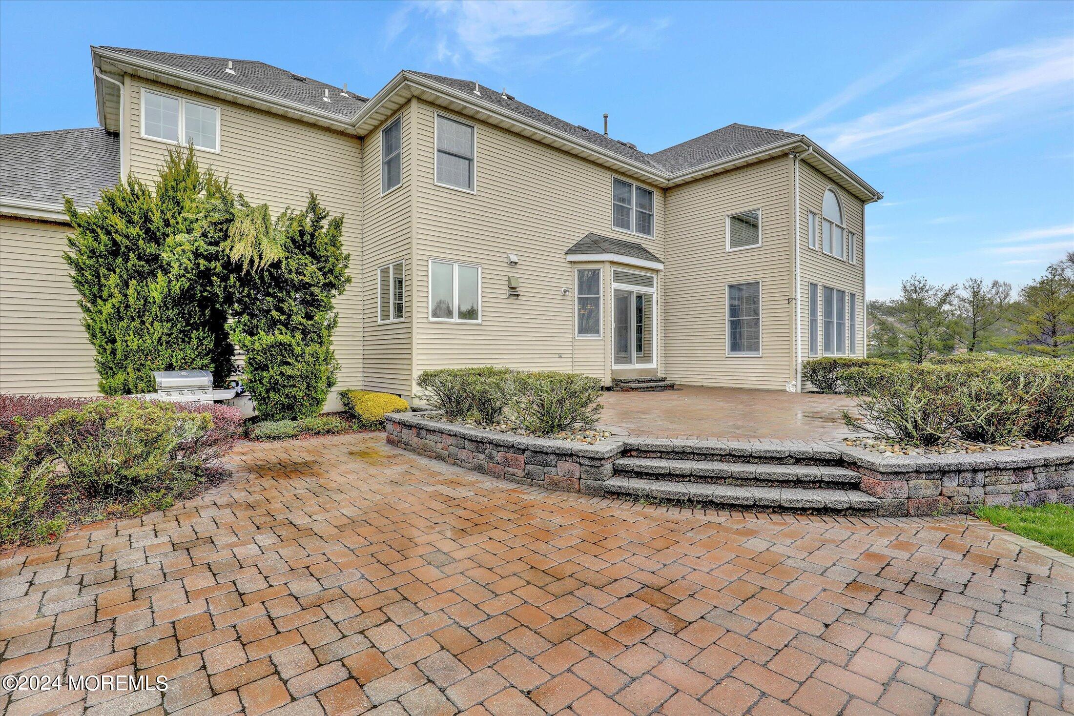 9 Shady Tree Lane Colts Neck, NJ 07722 - Photo 55 of 60 a front view of a house with a yard