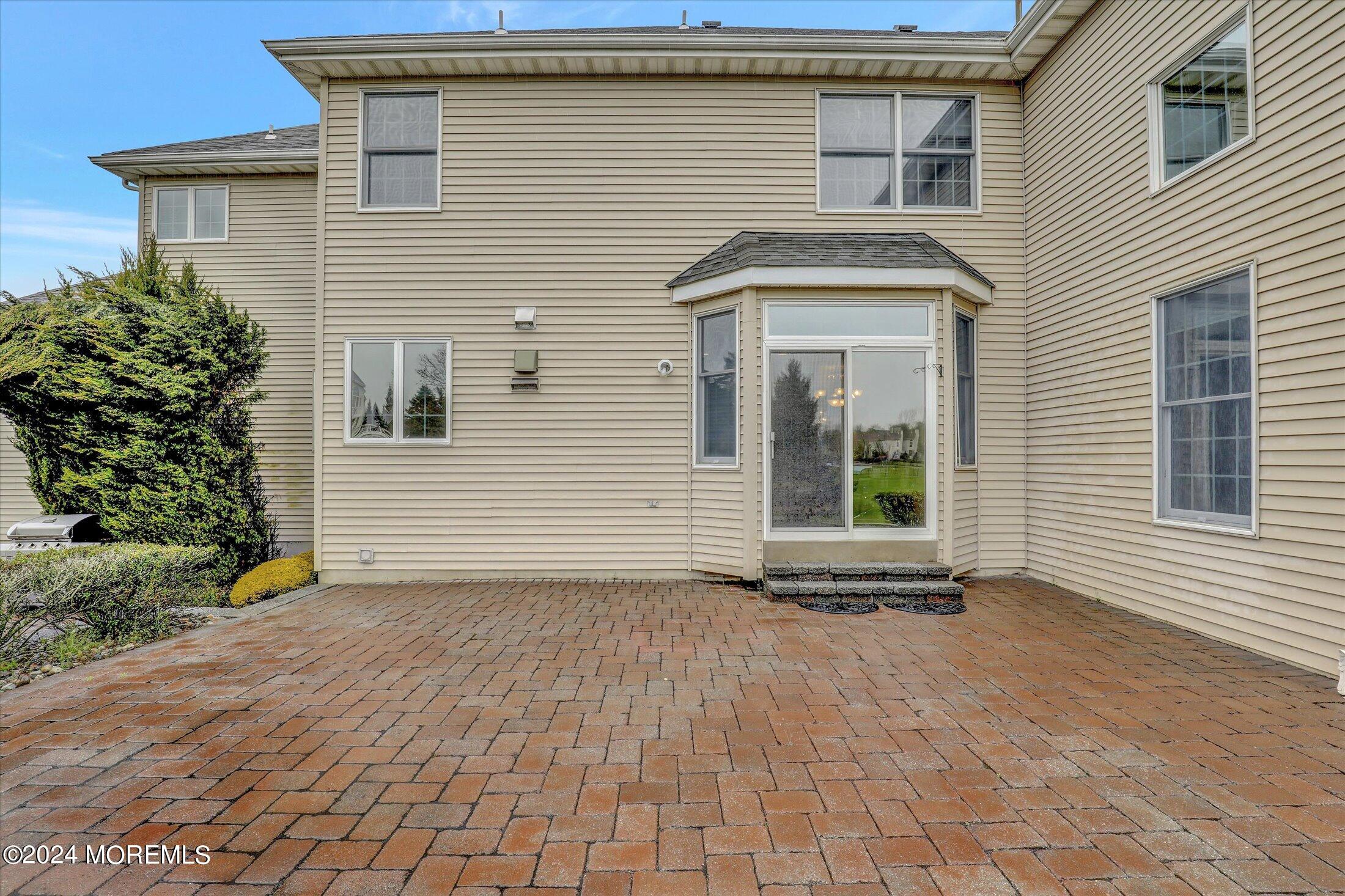 9 Shady Tree Lane Colts Neck, NJ 07722 - Photo 56 of 60 a view of a house with a white door and a window