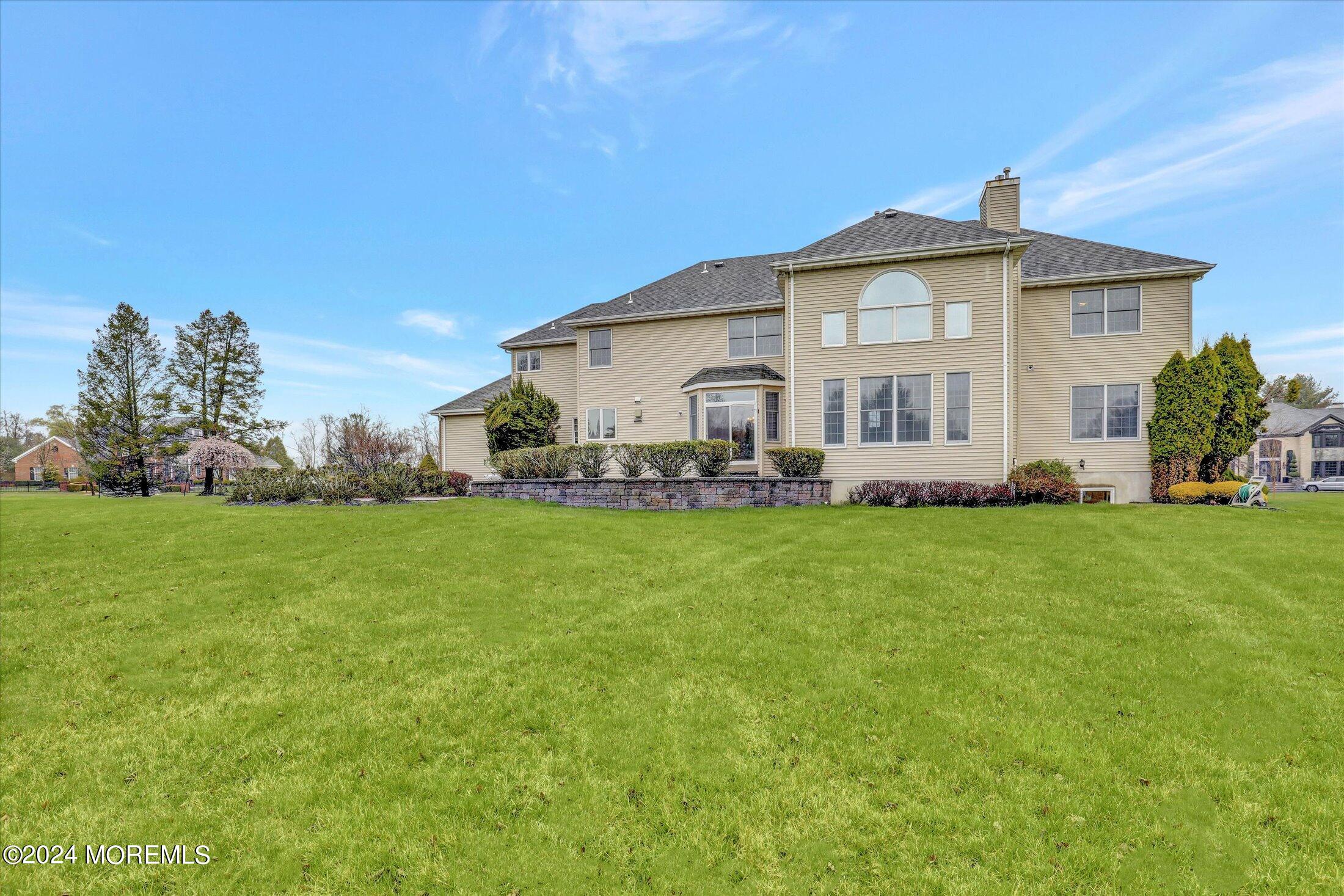 9 Shady Tree Lane Colts Neck, NJ 07722 - Photo 57 of 60 a front view of a house with garden