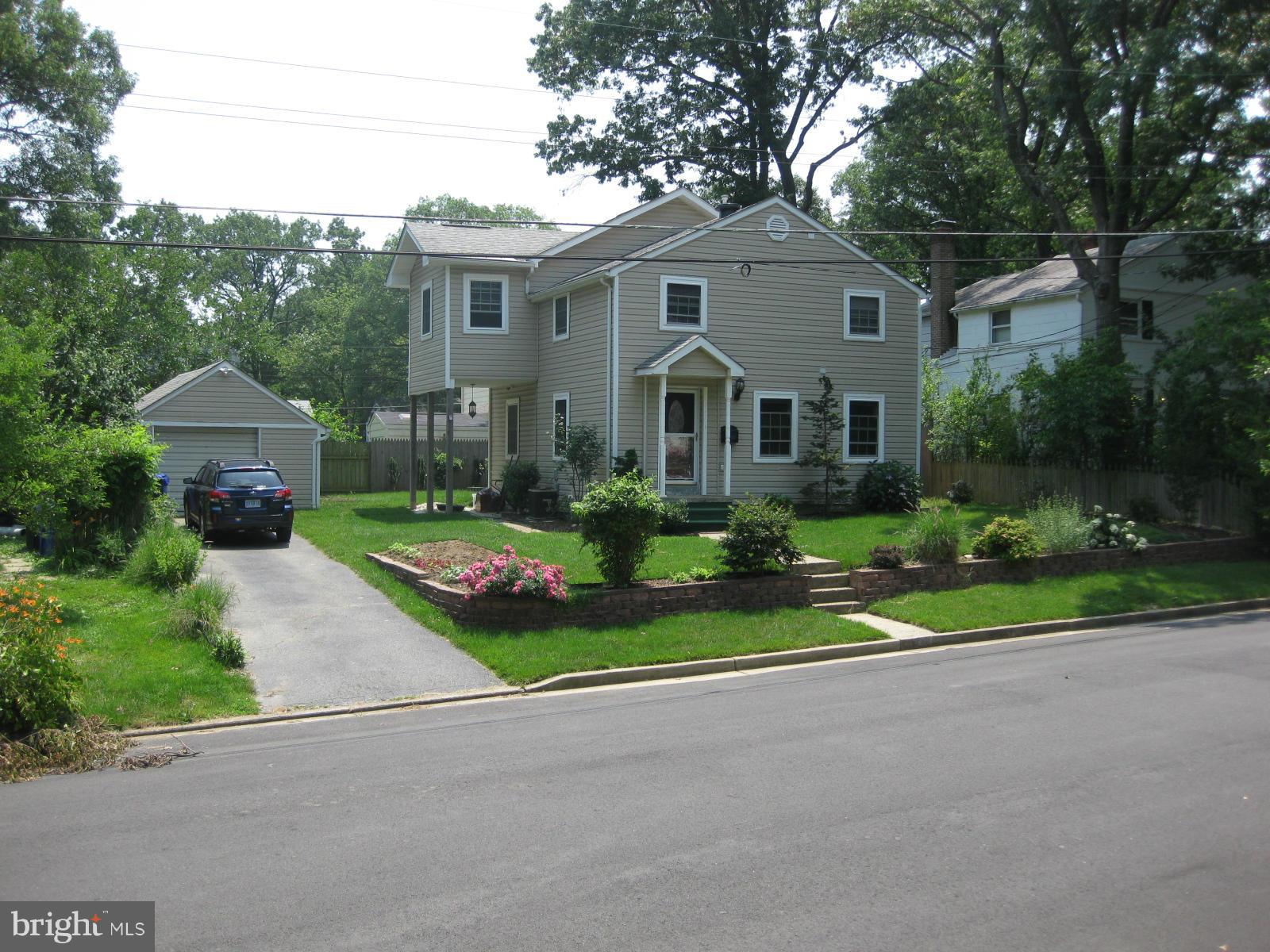 5112 11th Road South Arlington, VA 22204 - Photo 1 of 9 a front view of a house with a garden and trees