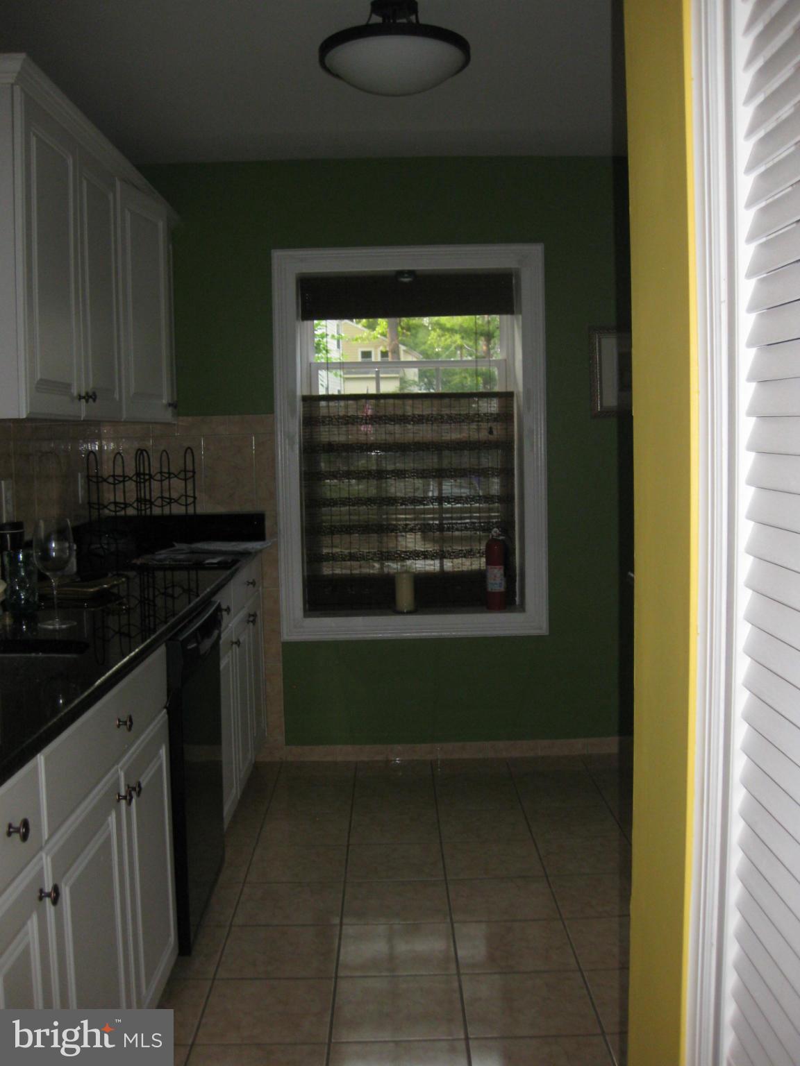 5112 11th Road South Arlington, VA 22204 - Photo 5 of 9 a kitchen with a refrigerator and a stove top oven