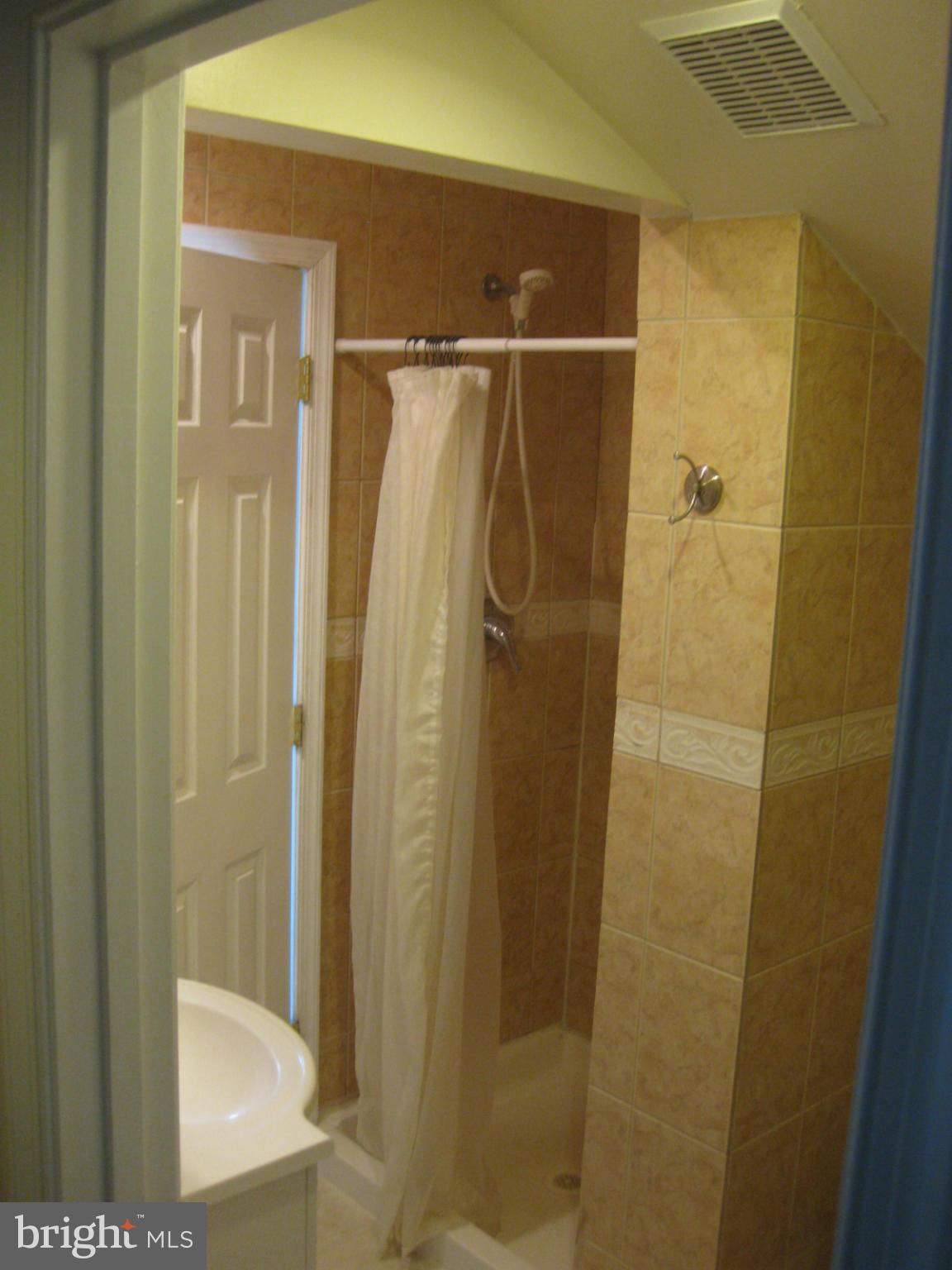 5112 11th Road South Arlington, VA 22204 - Photo 7 of 9 a bathroom with a glass shower door