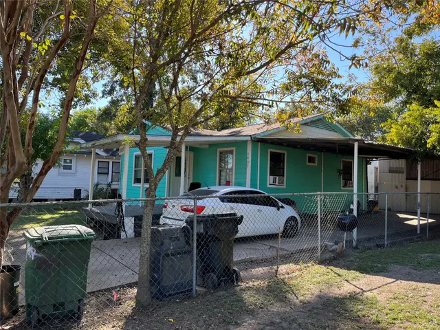 a view of a house with backyard sitting area and porch