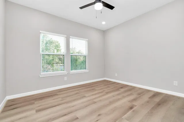 wooden floor in an empty room with a window