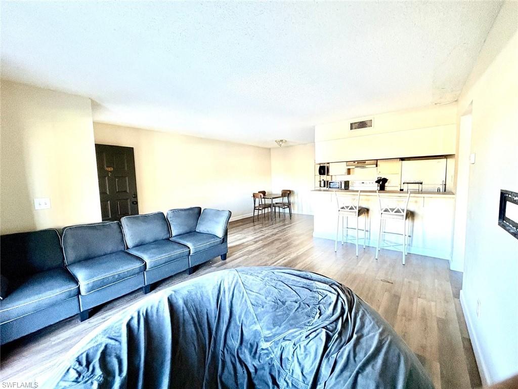 5315 Summerlin Road, Unit 1508 Fort Myers, FL 33919 - Photo 15 of 46 a living room with furniture and wooden floor