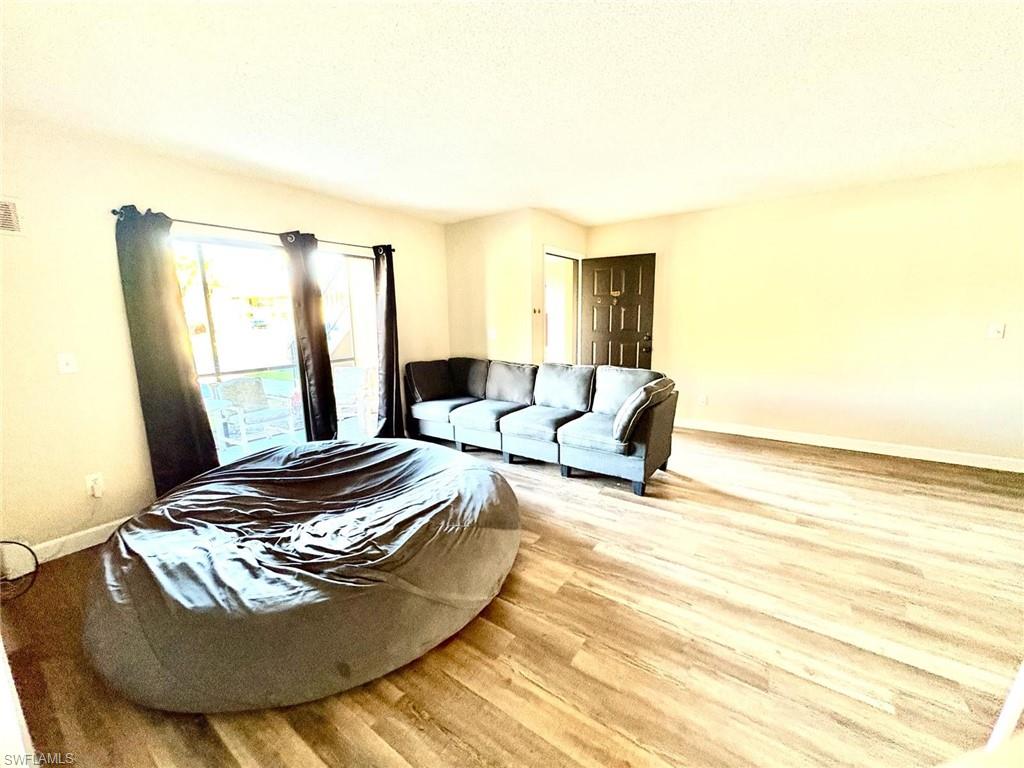 5315 Summerlin Road, Unit 1508 Fort Myers, FL 33919 - Photo 16 of 46 a living room with furniture and a window