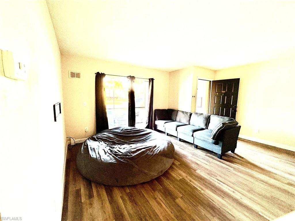 5315 Summerlin Road, Unit 1508 Fort Myers, FL 33919 - Photo 24 of 46 a living room with furniture and a wooden floor