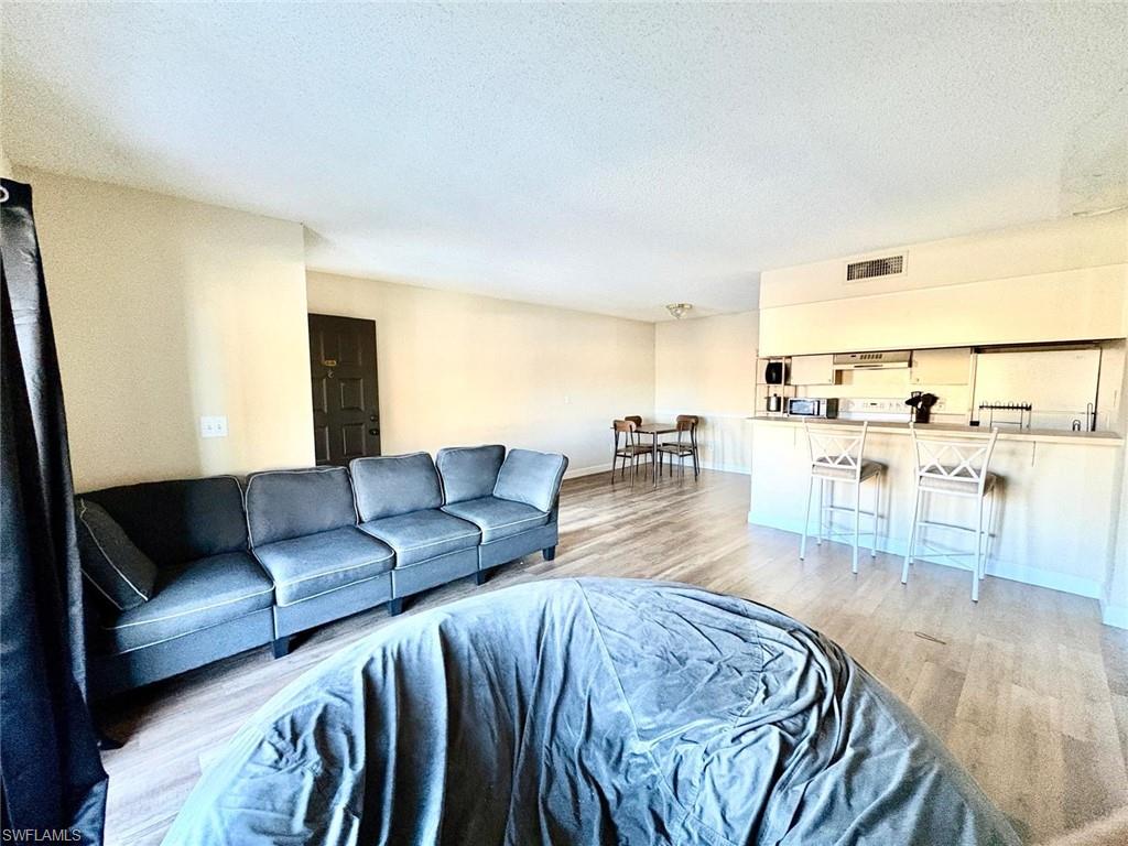 5315 Summerlin Road, Unit 1508 Fort Myers, FL 33919 - Photo 25 of 46 a living room with furniture and view of kitchen