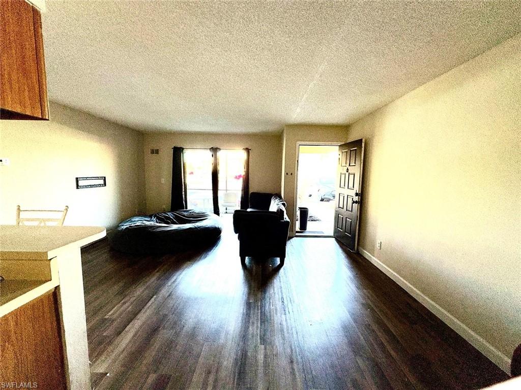 5315 Summerlin Road, Unit 1508 Fort Myers, FL 33919 - Photo 36 of 46 a living room with furniture and a large window