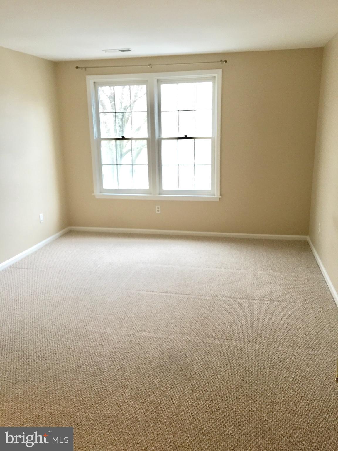 10715 Kings Riding Way, Unit 202 North Bethesda, MD 20852 - Photo 16 of 17 an empty room with a empty space and windows