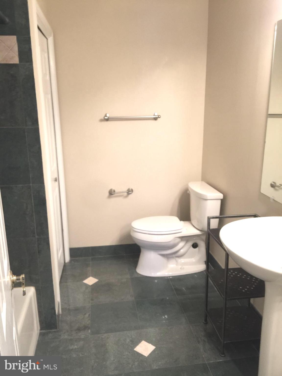 10715 Kings Riding Way, Unit 202 North Bethesda, MD 20852 - Photo 17 of 17 a bathroom with a toilet a sink and a shower