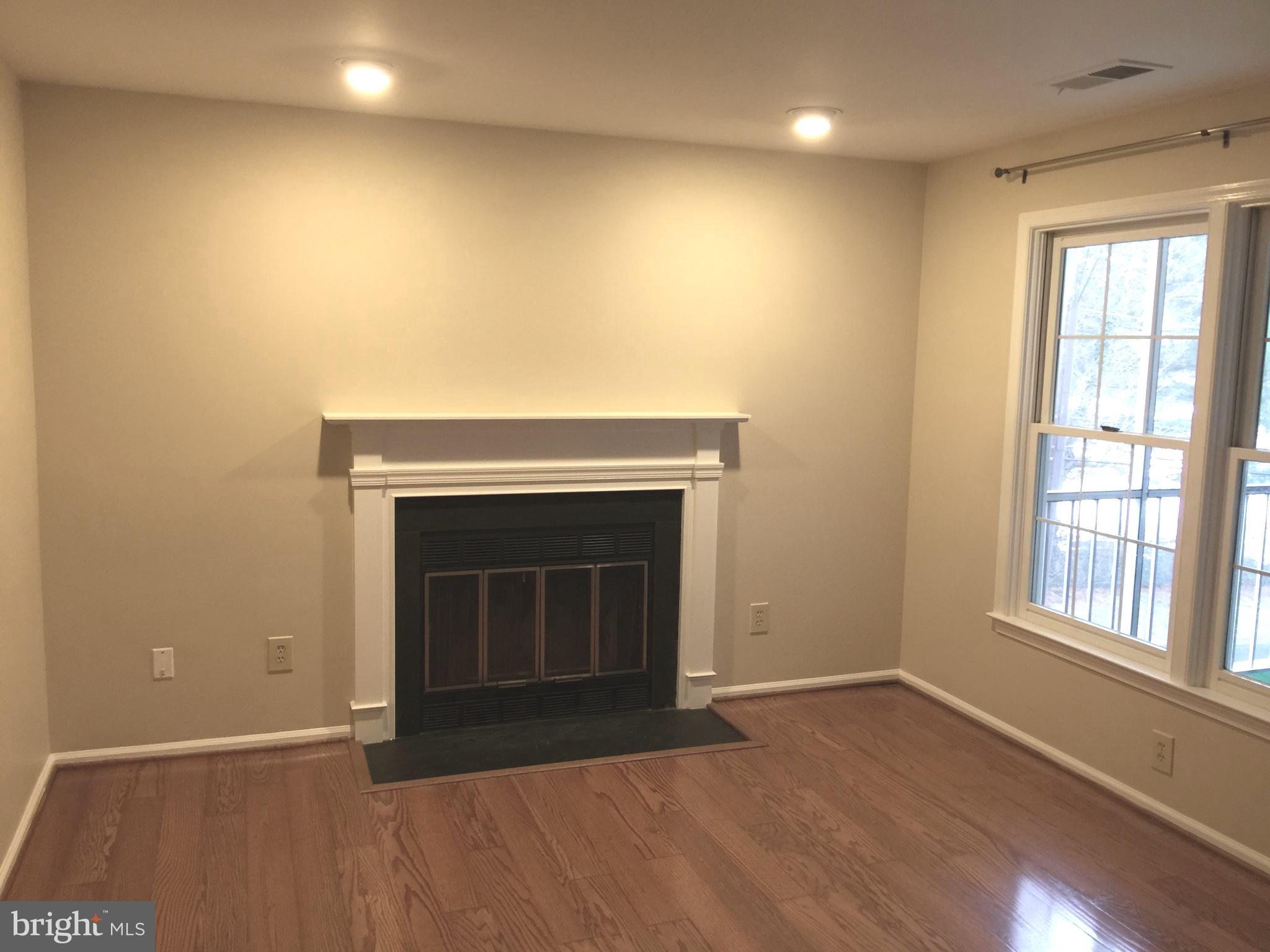 10715 Kings Riding Way, Unit 202 North Bethesda, MD 20852 - Photo 8 of 17 an empty room with windows and fireplace