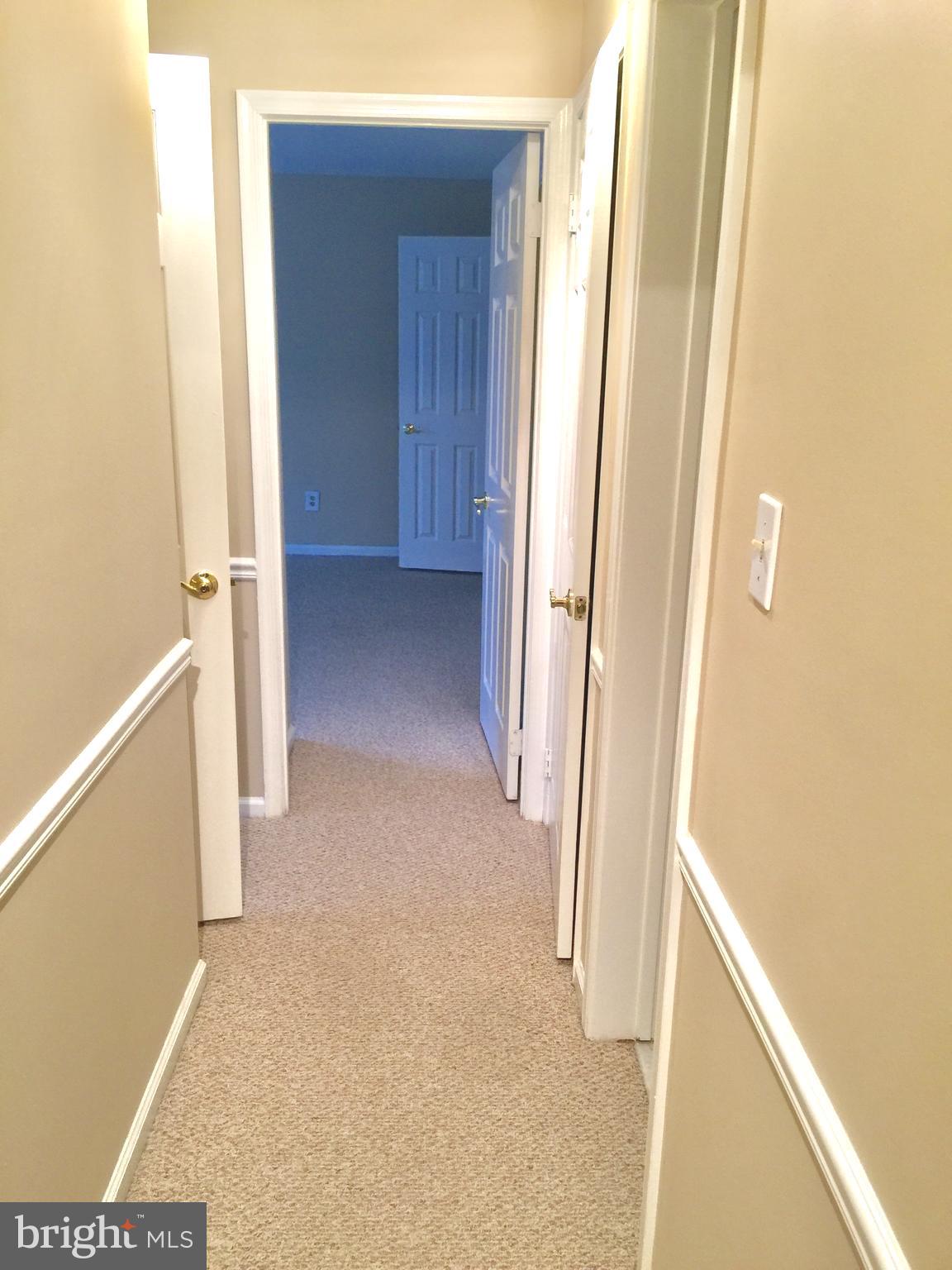 10715 Kings Riding Way, Unit 202 North Bethesda, MD 20852 - Photo 10 of 17 a view of a hallway with wooden floor