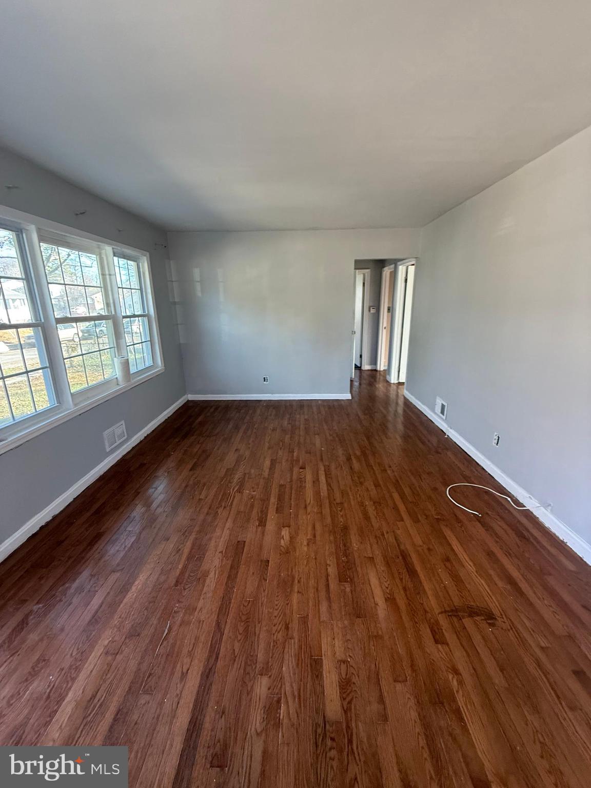 7003 Fairwood Road Hyattsville, MD 20784 - Photo 2 of 30 wooden floor in an empty room with a window