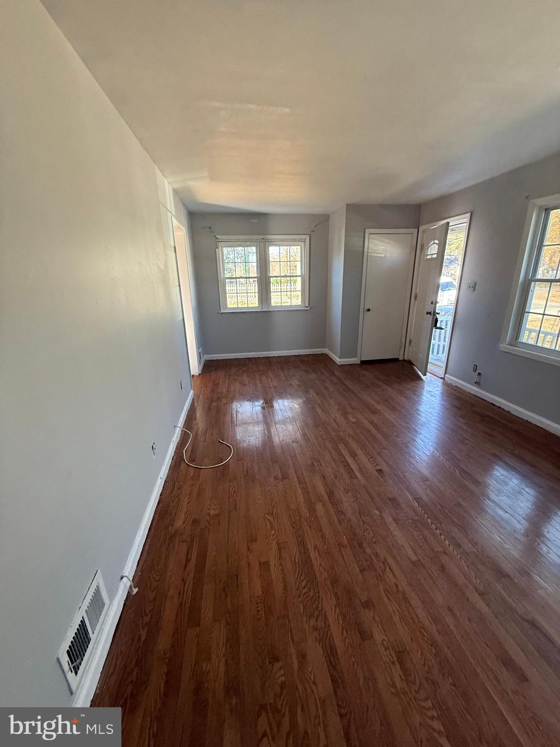 7003 Fairwood Road Hyattsville, MD 20784 - Photo 3 of 30 an empty room with wooden floor and windows