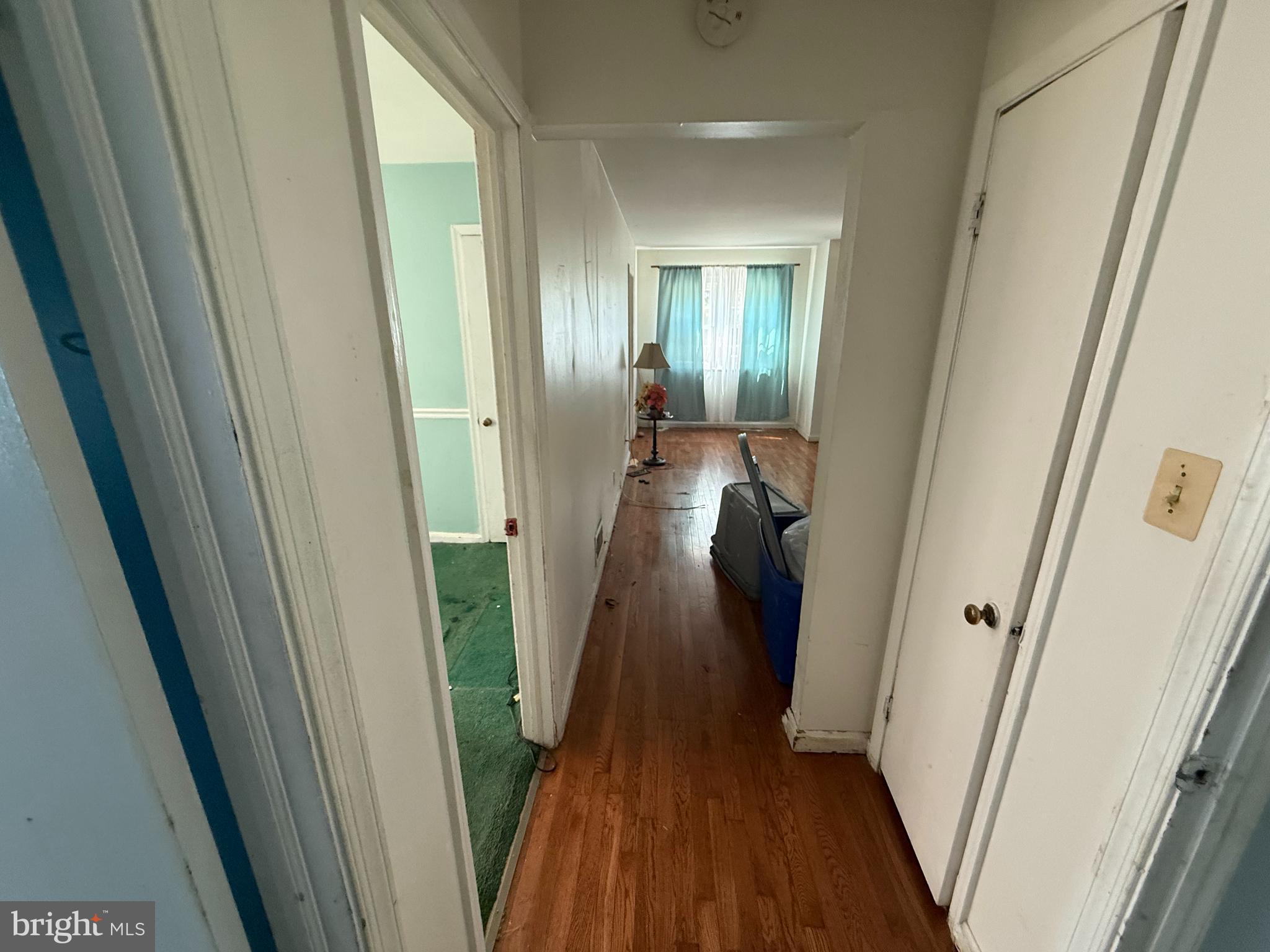 7003 Fairwood Road Hyattsville, MD 20784 - Photo 4 of 30 a view of a hallway with wooden floor and stairs