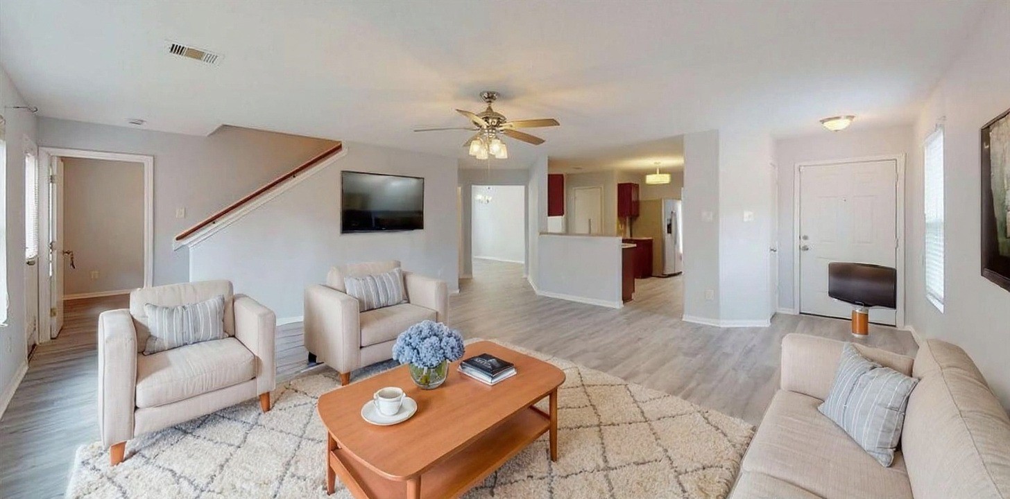 9877 Lace Flower Way Conroe, TX 77385 - Photo 5 of 43 a living room with furniture and a flat screen tv