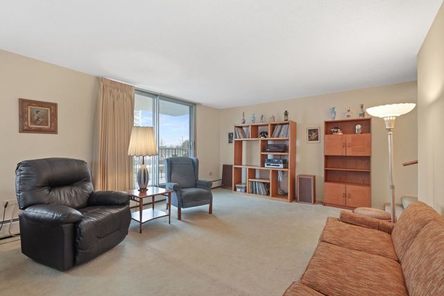 8809 West Golf Road, Unit 2B Niles, IL 60714 - Photo 2 of 17 a living room with furniture and a large window